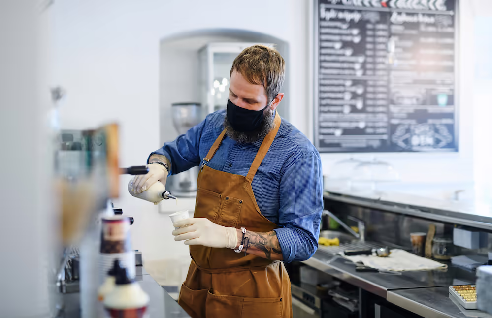 Small coffee business barista pouring coffee